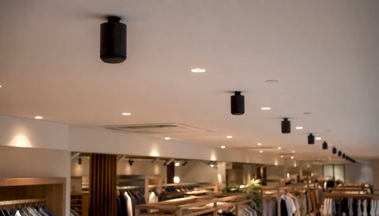 Ceiling speakers arranged in grid pattern in retail store